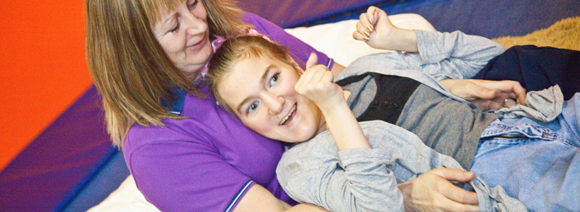 Young girl with disabilities and her carer